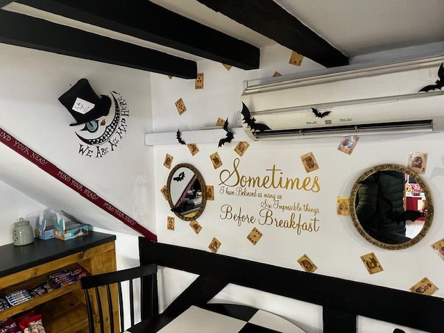 Wonderland-themed wall inside Queen of Tarts