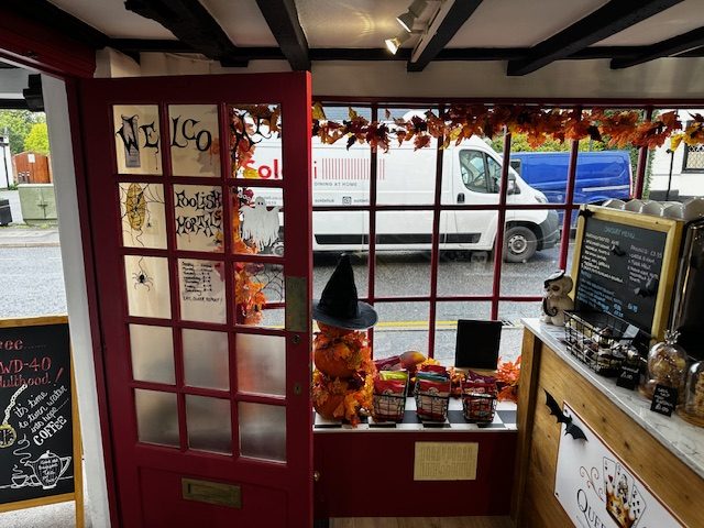 The red door and windows of Queen of Tarts, Chobham